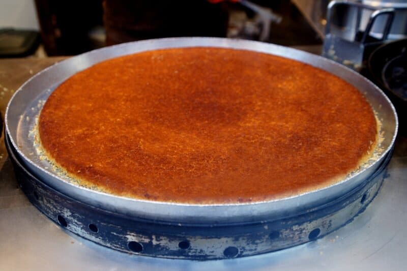 A whole kunafa baked in a kunafa shop in dubai before it has been cut