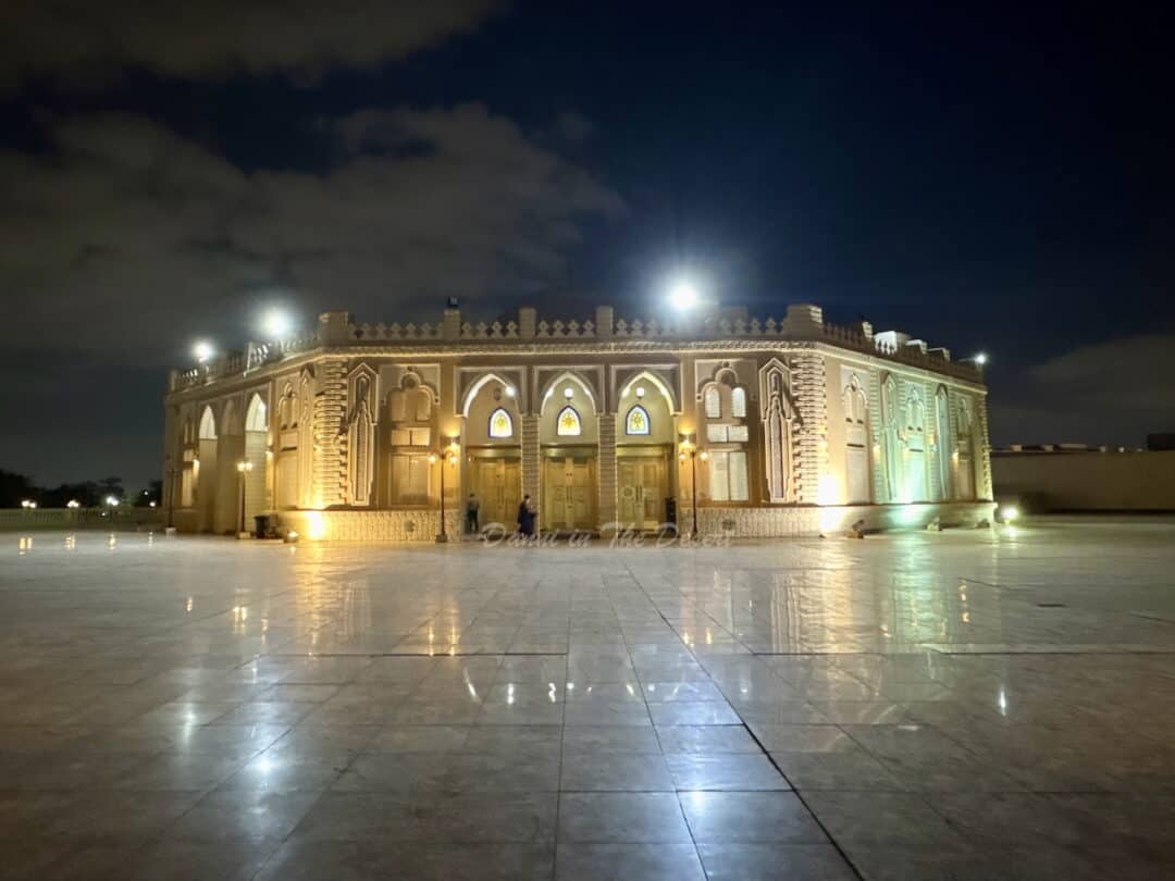 Mirdif Grand Mosque in Dubai at night, lit up showing the men's entrance from the ground floor