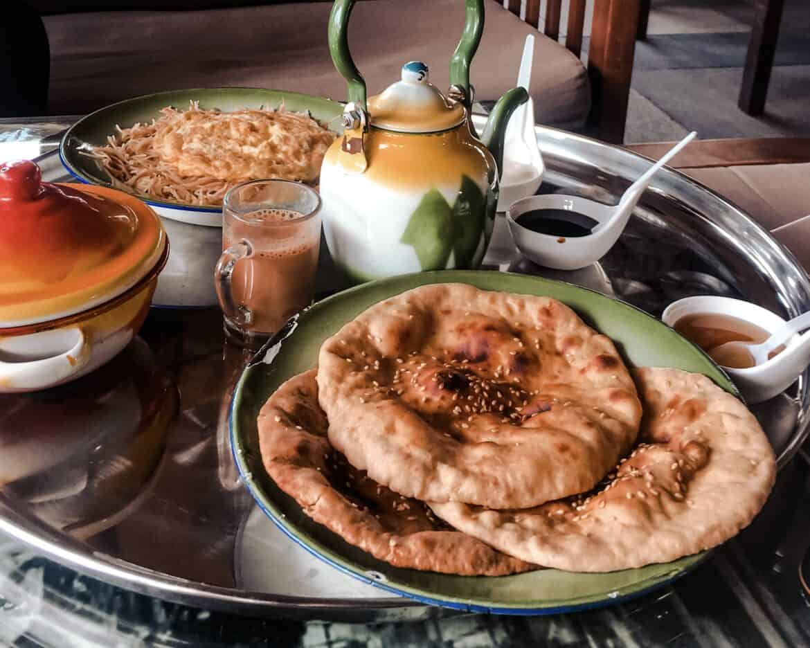 Traditional emirati breakfast served on a silver platter with karak tea
