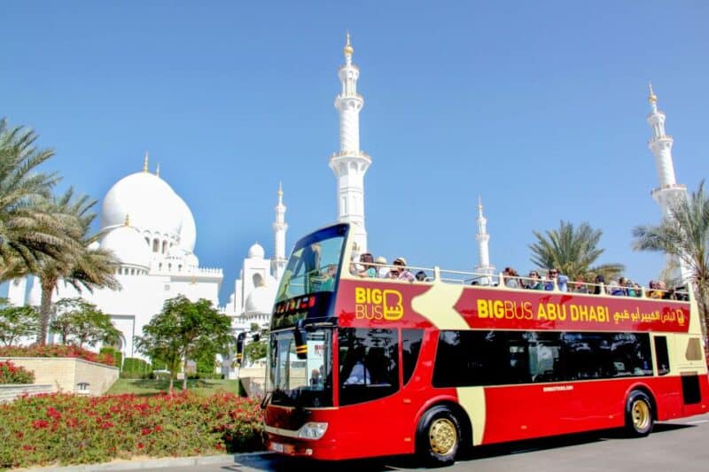 Big bug tours Dubai to Abu Dhabi free shuttle bus sat outside Sheikh Zayed Grand Mosque