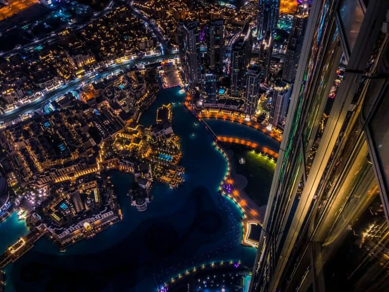 aerial photography from the Burj Khalifa looking down at the Dubai cityscape at night, over old town and Dubai Fountain