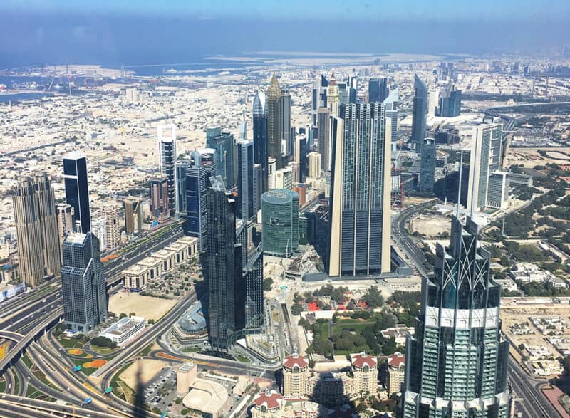 View from top of Burj Khalifa with view over DIFC in Dubai and Sheikh Zayed Road