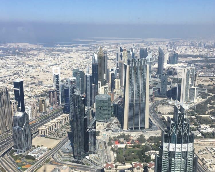 View from out of the window inside Burj Khalifa at At.Mosphere restaurant during the day time, looking towards Dubai International Financial District or DIFC.