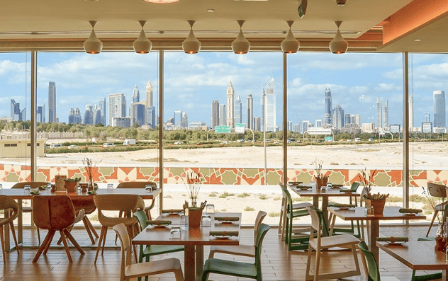 View of the Dubai skyline from Eat Well in Zabell and the tables by the window