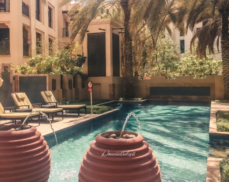Swimming pool with sun loungers in a residential complex in Old Town, Downtown Dubai for residents only