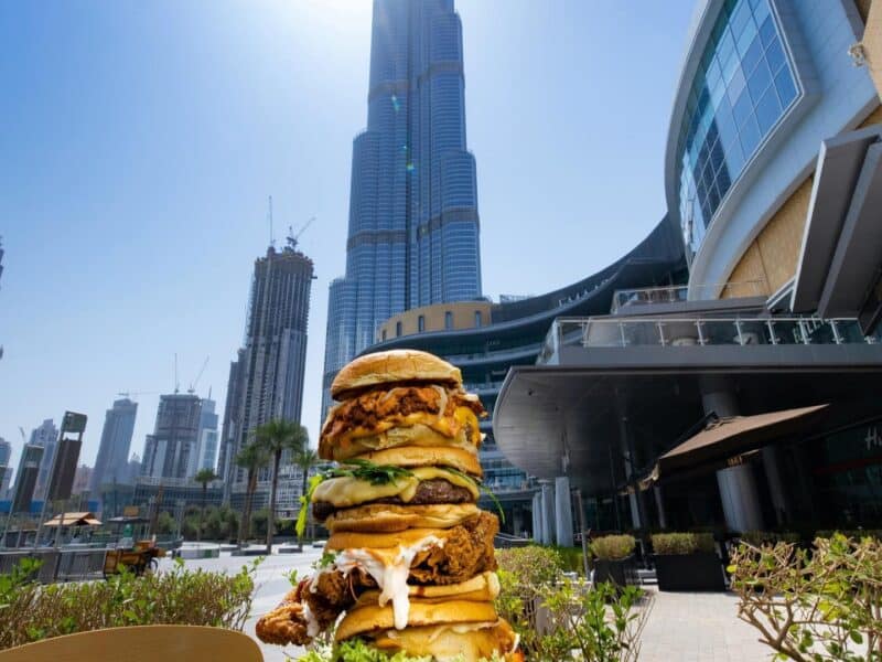 Burgers stacked on top of each other on the outdoor tables at Black Tap Dubai Mall