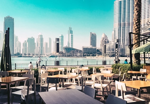 Outdoor seating area in front of Dubai Fountain with Dubai Opera and Burj Khalifa