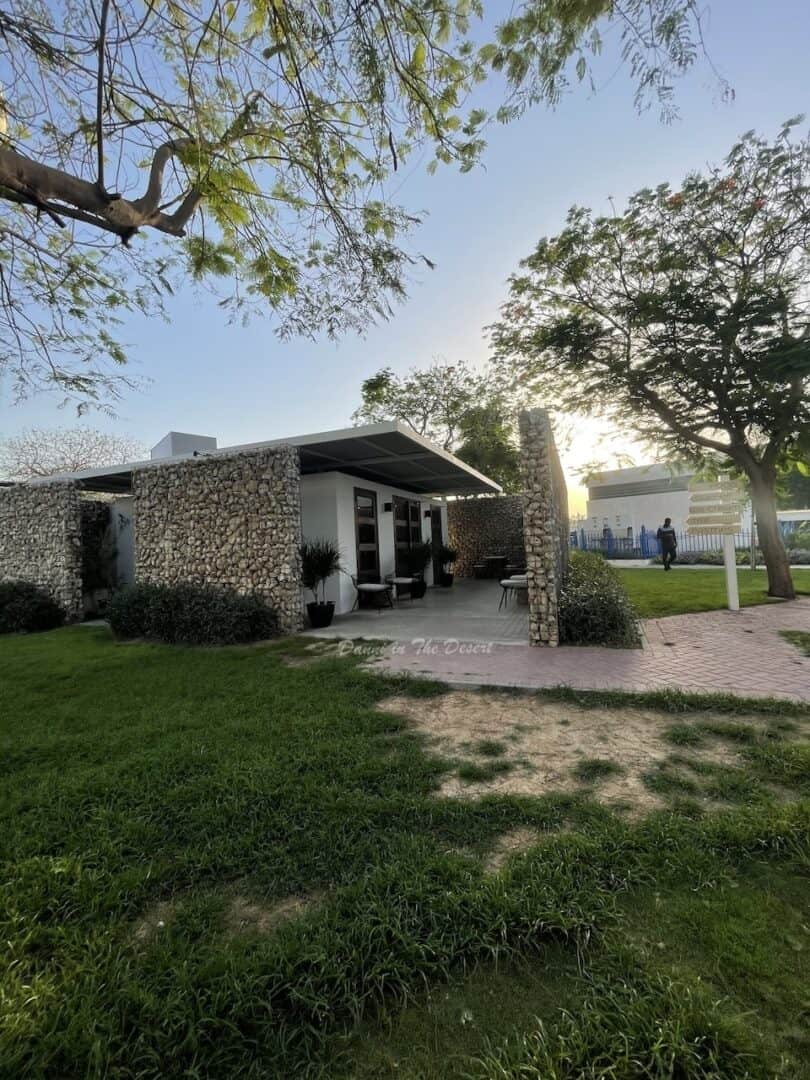 Exterior made from unique brick of Barn Cafe with outdoor seating terrace at the entrance inside Al Khan Park