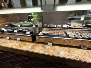 A selection of seafood laid out at a buffet restaurant in Dubai with brown marble countertops