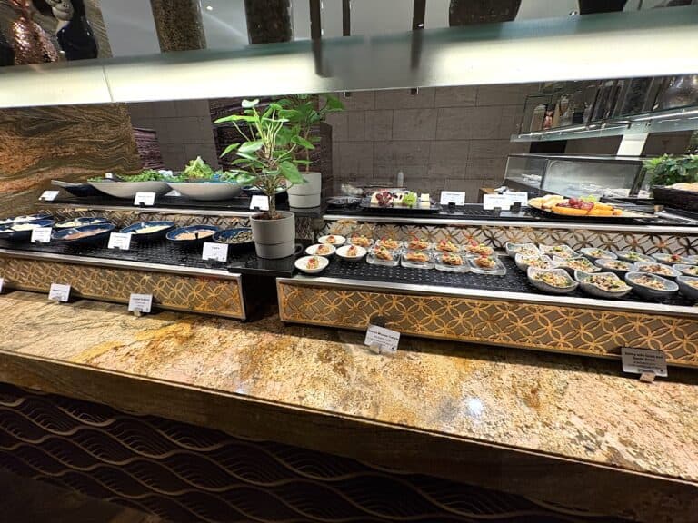A selection of seafood laid out at a buffet restaurant in Dubai with brown marble countertops