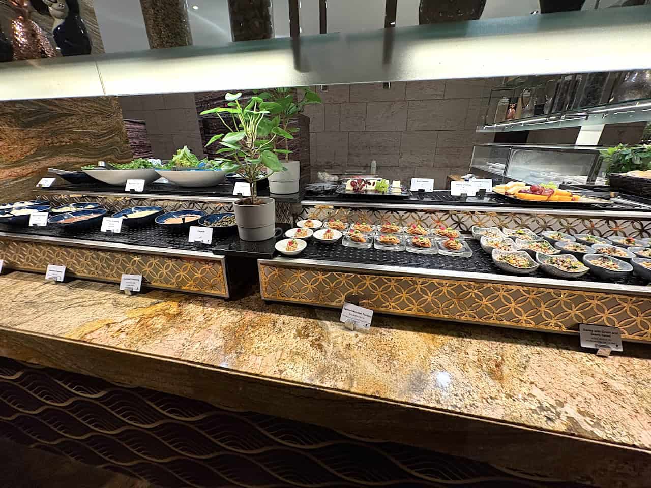 A selection of seafood laid out at a buffet restaurant in Dubai with brown marble countertops