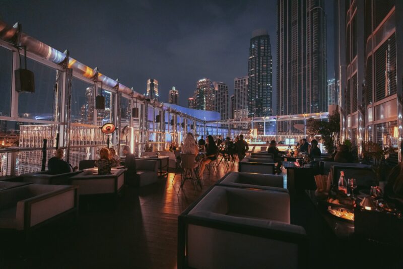 The outdoor terrace area of BKH at Burj Khalifa Dubai with people enjoying a night out