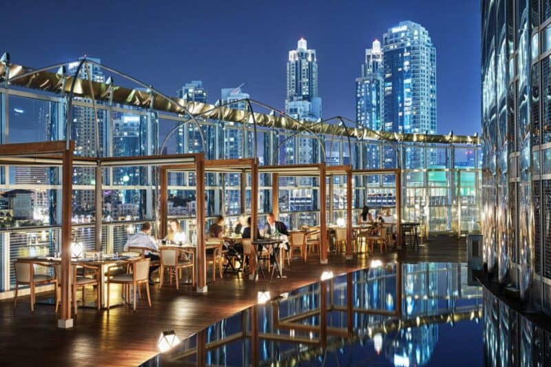 The outdoor terrace of Amal Restaurant in Dubai with a view over Dubai Fountain