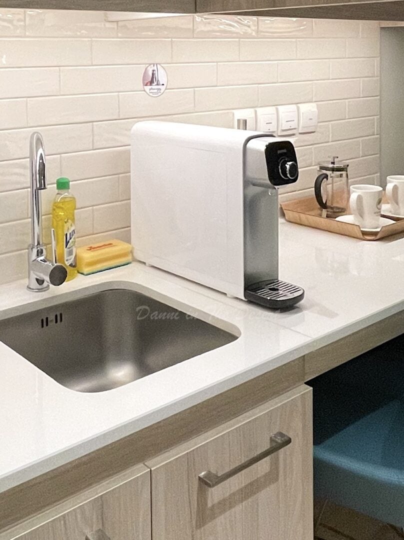 A white water filter on the kitchenette side of a Dubai hotel called Element Al Jaddaf that gives guests unlimited filtered water