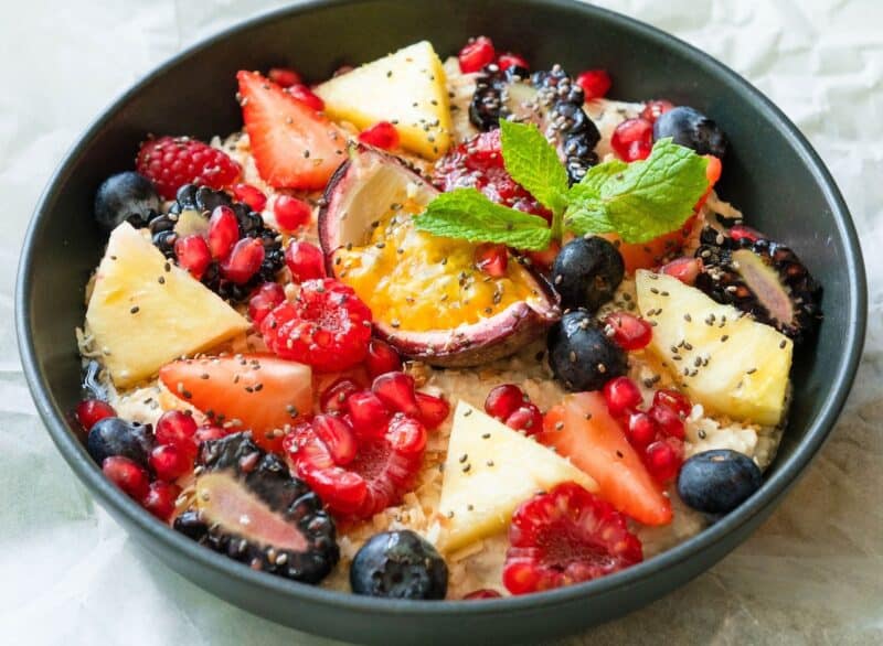 A fruit bowl served in a black ceramic bowl from Roseleaf Cafe