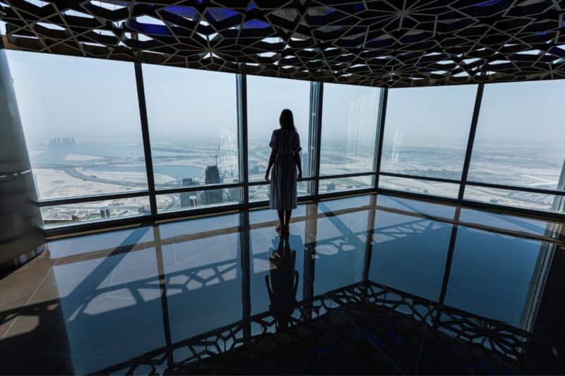 The indoor observation deck at Burj Khalifa with a woman looking out at the view