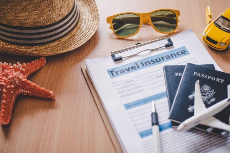 travel documents for Dubai and Dubai travel insurance on a desk