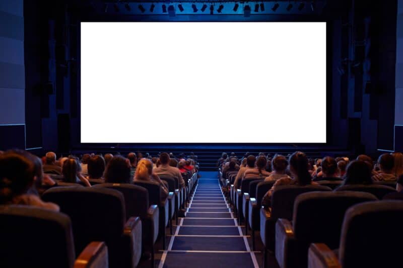 Cinema screen with people waiting to watch a film