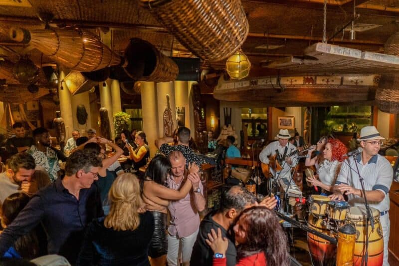 A night out dancing at trader vics at Madinat Jumeirah with its tiki style interiors and live band. People dancing after some tasty cocktails