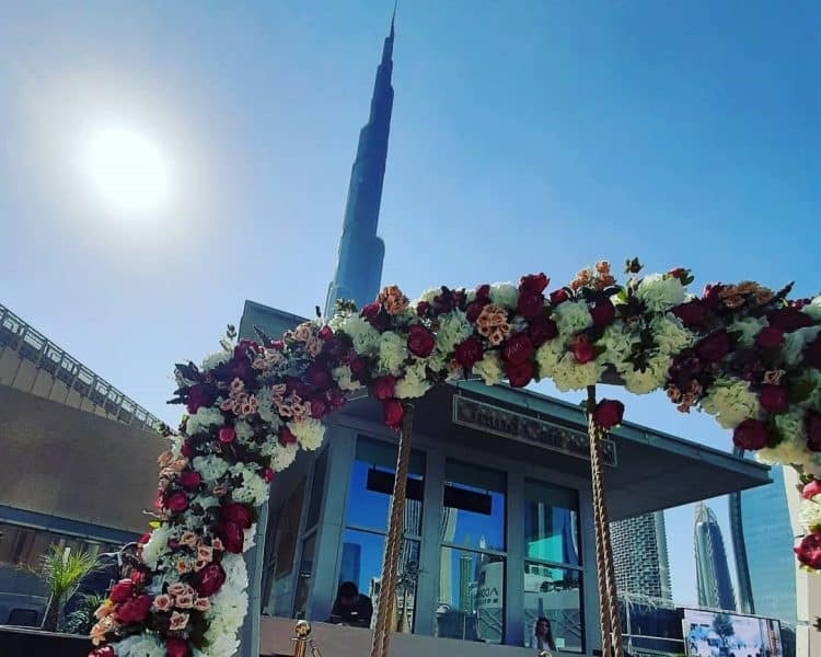 View of the Burj Khalifa from Grand Cafe Boulevard with a flower arch