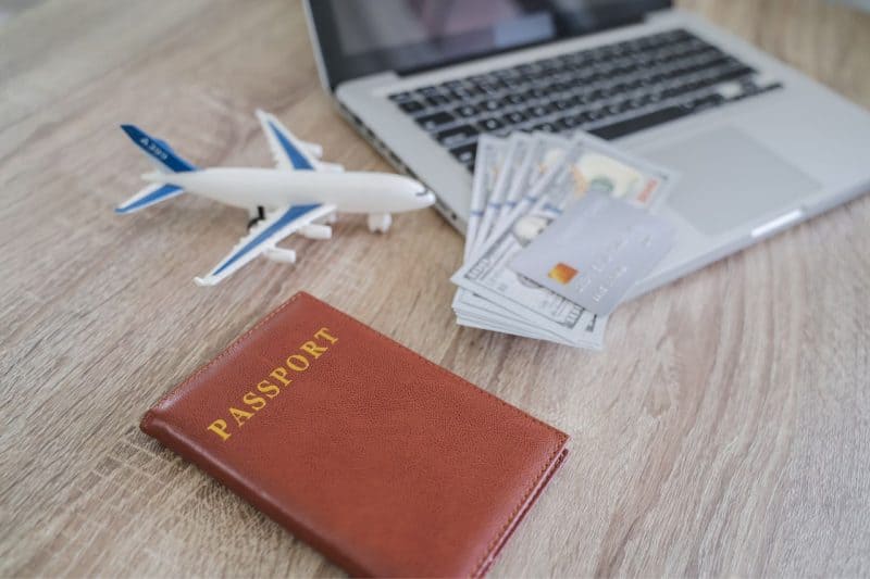 Passport, card, cash and a laptop ready to book an Emirates flight