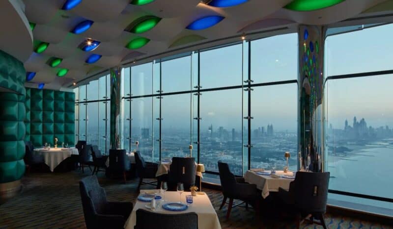 The view towards Dubai Marina and seating with tables set up from Al Muntaha in Burj Al Arab