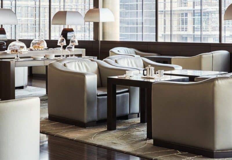 Comfortable looking seating inside the Armani Lounge with hot drinks set on the table