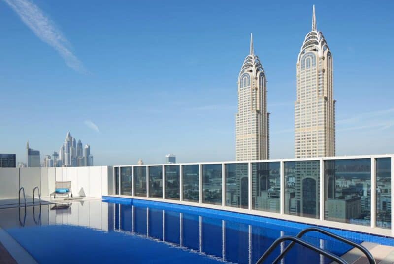 Rooftop swimming pool with a view over Central Dubai at Dusit D2 Kenz Hotel