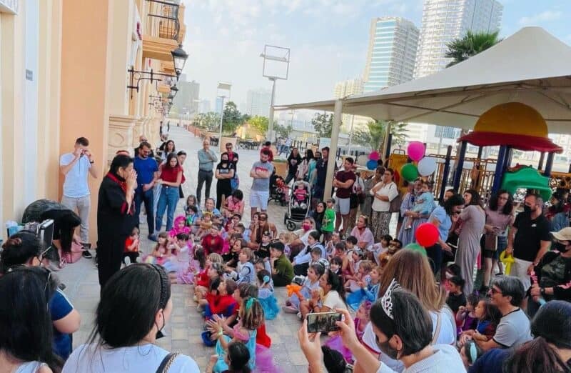 Kids watching a show close to the outdoor playground at Pulcinella's in Sports City Dubai