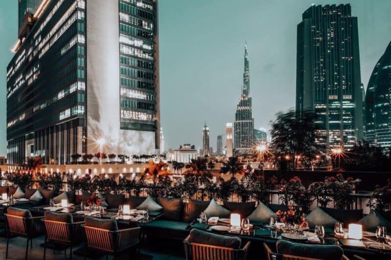 The DIFC and Downtown Dubai skyline view lit up at night from the outdoor seating area of Roberto's Restaurant in DIFC