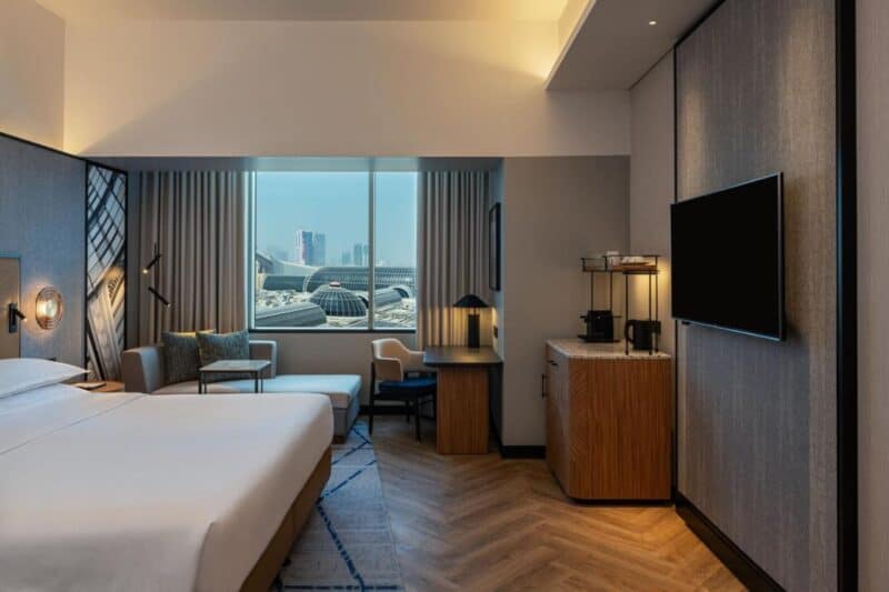 Room with a king size bed inside Sheraton Mall of Emirates with a view overlooking the mall