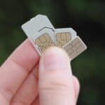 holding up sim cards in their hand