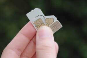 holding up sim cards in their hand