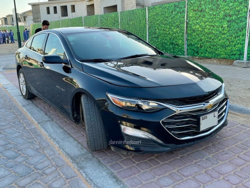 Black malibu Chevrolet rented in Dubai as a car rental, parked at the side of the road 