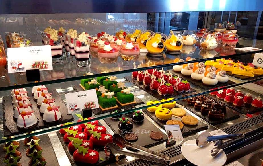 Christmas themed desserts in a range of classic Christmas colours, arranged in a display fridge for people to choose from and enjoy at a Christmas Brunch in Dubai