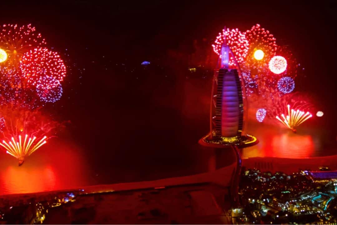 Red and blue fireworks going off around the Burj Al Arab on New Year's Day