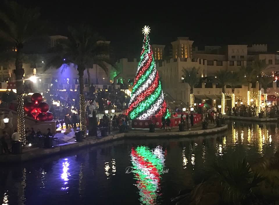 One of the largest Christmas trees in Dubai lit up at night at a Madinat Jumeirah Souk