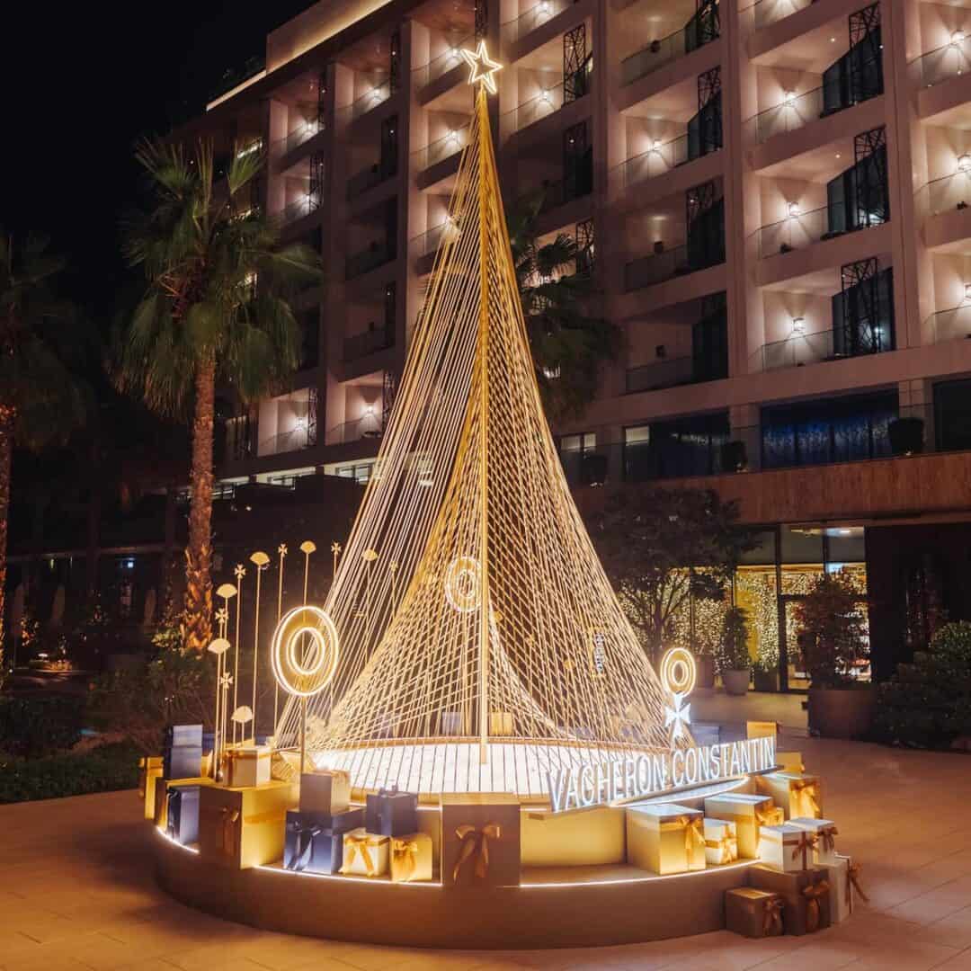 The 2023 designer Christmas tree lit up at night by Vacheron Constantin, outside at The Mandarin Oriental Jumeira Dubai hotel