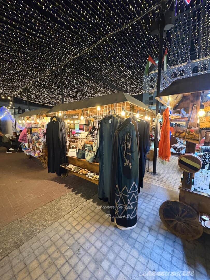 Abayas for sale at the Christmas Souq inside Winter Garden along with other small stalls set up in wooden huts selling various goods