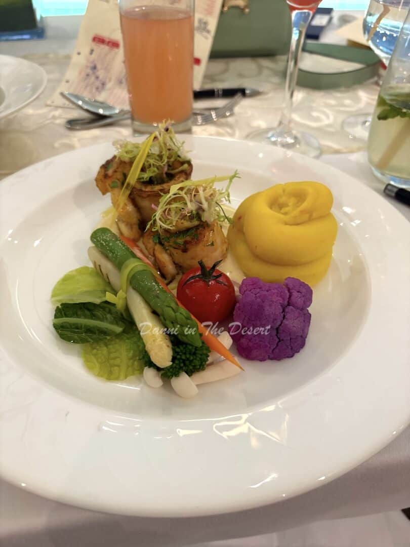 Main meal of Dover Sole served with saffron mashed potato and vegetables, served on a white porcelain plate in the Winner's Circle restaurant