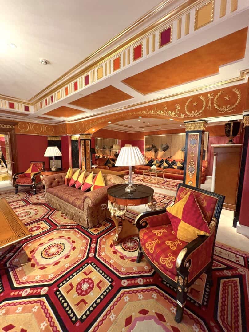 Majlis inside the Royal Suite of the Burj Al Arab with red and yellow seating and intricate orange carpets