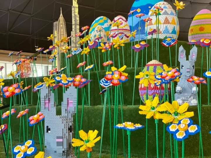 Lego easter eggs, flowers and bunnies tiered on fake grass as part of a display at Legoland Dubai