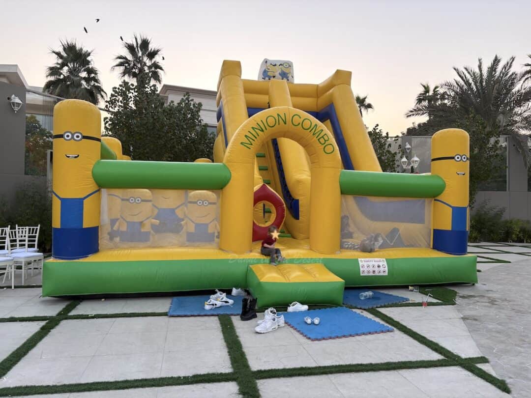 A minion themed yellow bouncy castle with a large inflatable slide at Address Emirates Hills brunch