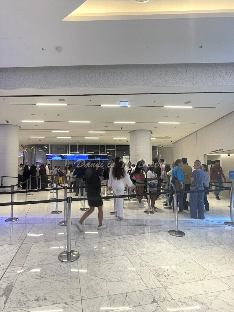 Queue of people standing in line at the entrance to At The Top inside Dubai Mall for access to the Burj Khalifa