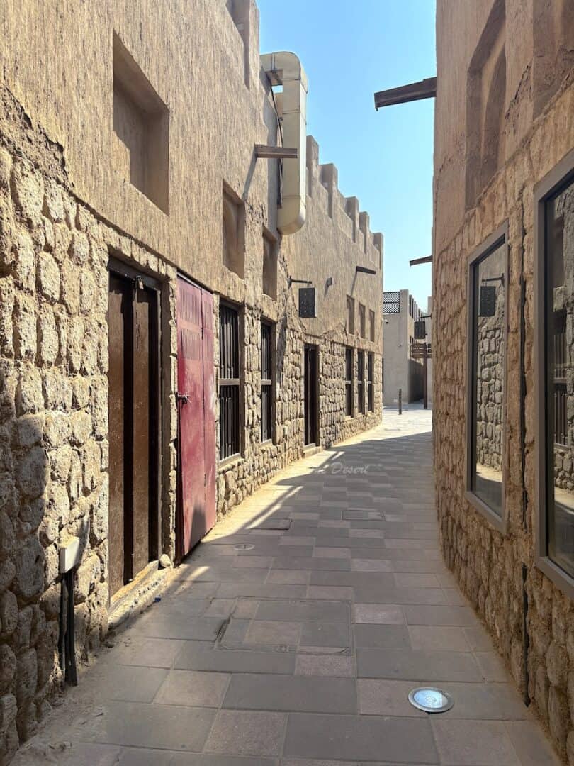 A historical Emirati street that curves round with tradtional style doors and windows as part of Al Shindagha Museum