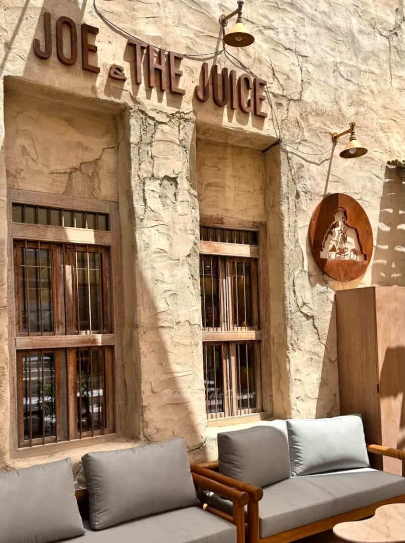 Joe & The Juice with their famous logo and branding in the style of traditional Emirati housing with seats and a table outside