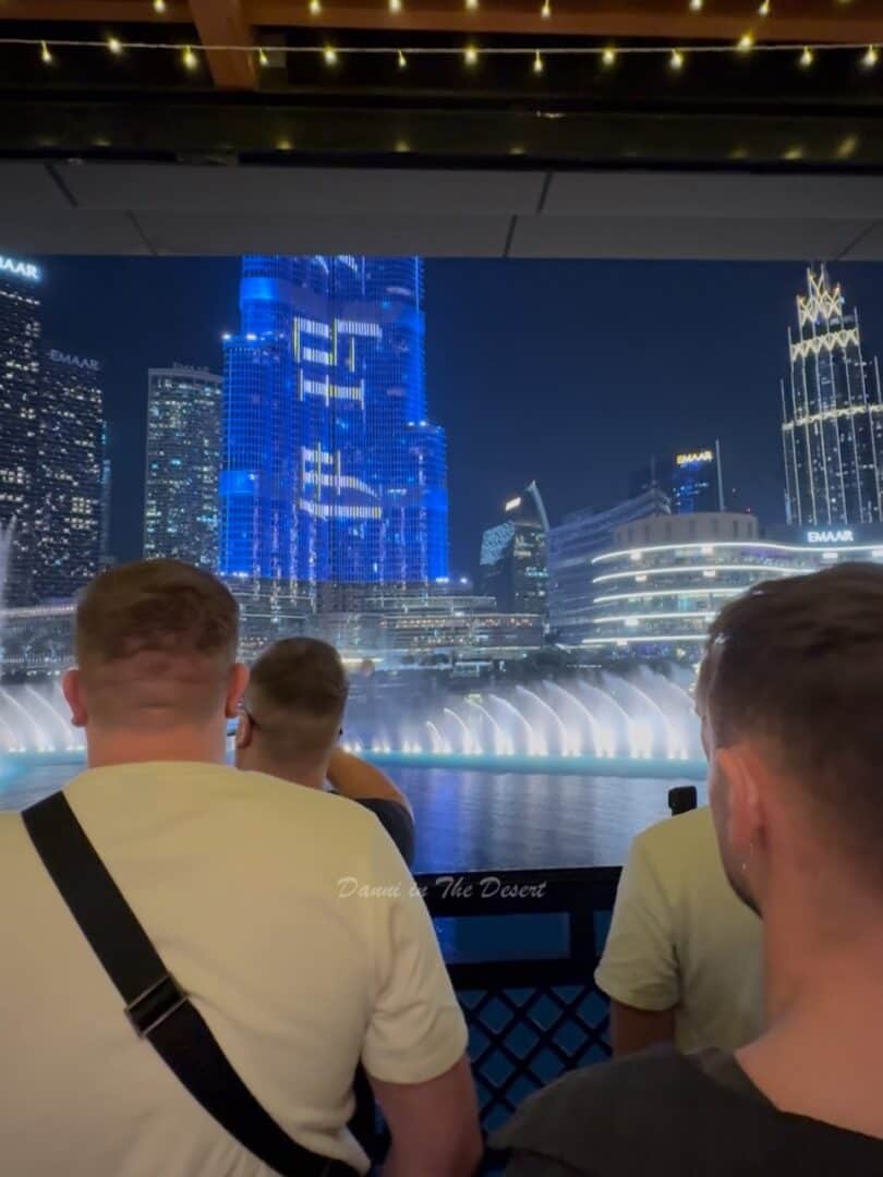 People standing in front of the view on Time Out Market's terrace as you watch Dubai Fountain and Burj Khalifa