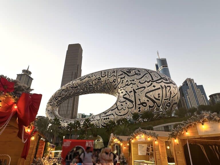 Museum of The Future at sunset during December in Dubai with the Christmas markets at the bottom of the photo